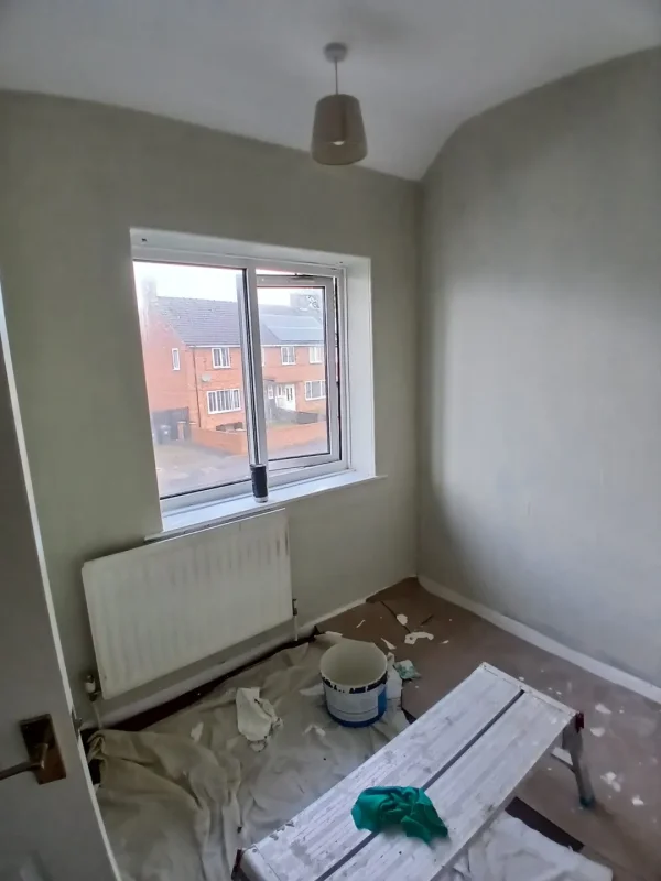 Wall preparation and painting in progress.
