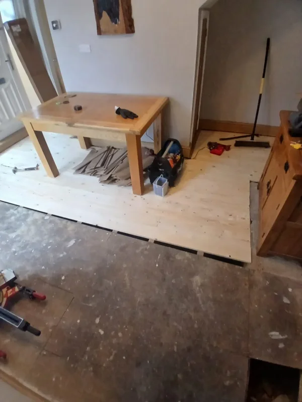 Replacement timber floorboards being fitted in the dining area.